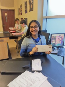 Smiling girl holding envelope
